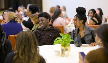 Students laughing in the Ath at the CARE Center anniversary celebration