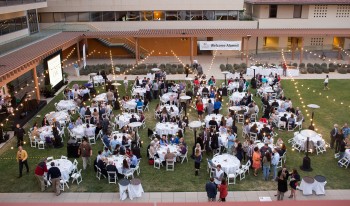 Alumni gather near the Kravis Center for an alumni weekend reception.