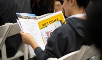 Student reviews a CMC welcome packet.