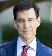headshot of Ted Gayer in blue suit