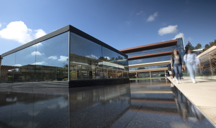 One of CMC's two architectural landmarks, "the Cube," stands in front of the Kravis Center as students walk by