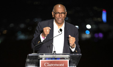 Michael Steele clenches his fists at the podium as he addresses the Res Publica Society dinner audience.