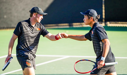 Two tennis players giving knuckle bump