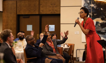 Dr. Diane White-Clayton in front of audience in the Ath