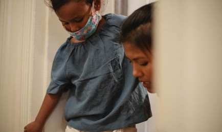 A woman is helping a child put on their shoes.