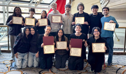 MUN students posing with their awards