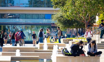 Students on campus with fountain and Kravis Center