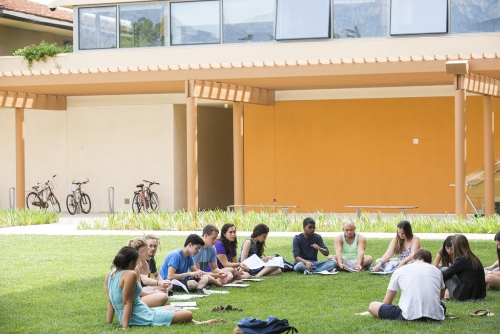 Students meeting on the Gann Quadrangle in front of the Kravis Center.