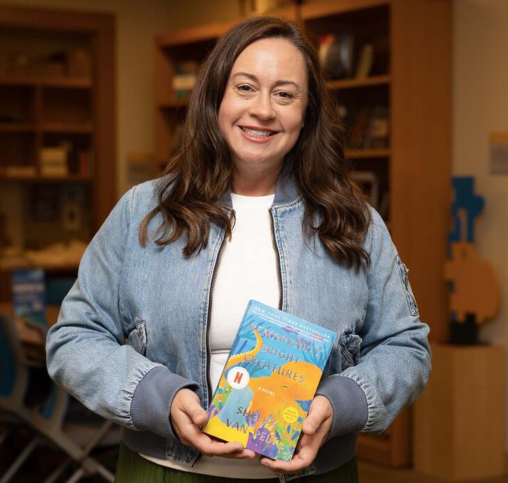 Shelby Van Pelt '02 holding her book, "Remarkably Bright Creatures"