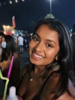 Photo of Athulya Nath at a night time festival.