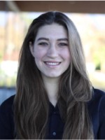 Photo of Helen Bovington outside a campus building.