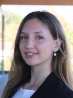 Smiling girl, named Milly, facing sideways.