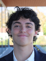 Smiling young person with curly hair