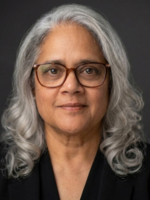 Woman wearing glasses; silver-haired.